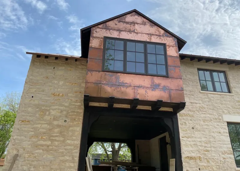 Copper metal panel facade on a stone building for Metal Roof Coating in Fallon