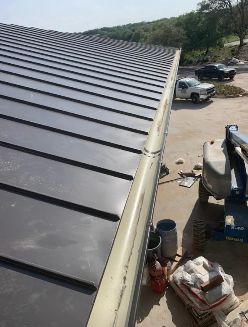 Standing seam panel and gutter detail on a metal roofing jobsite in Fallon